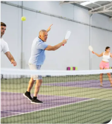 Pickleball action at the net during a FitCourts drop-in session